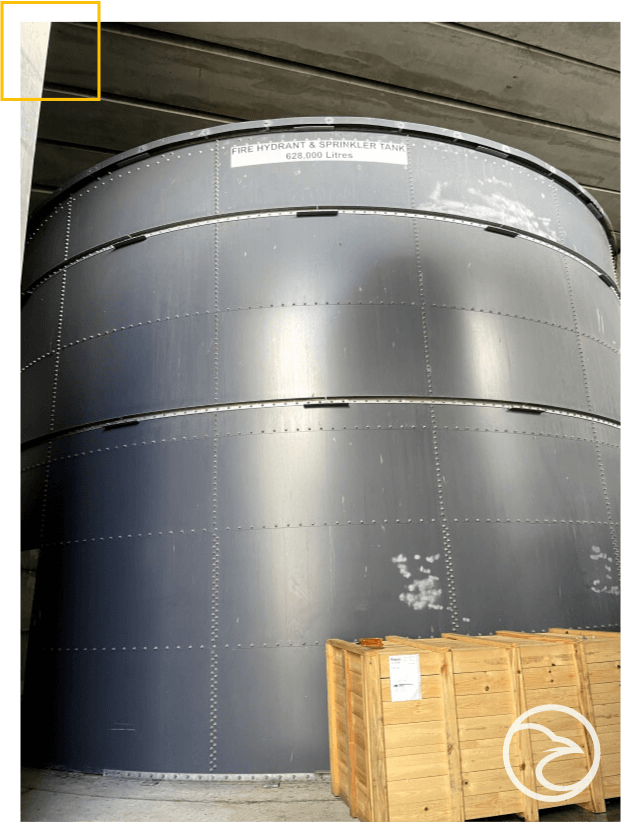 A large metal storage tank inside a facility, possibly for liquids, with a capacity of 625,000 liters.